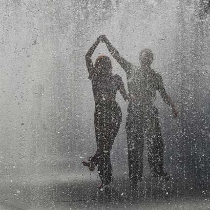 couple man and woman dancing in the rain